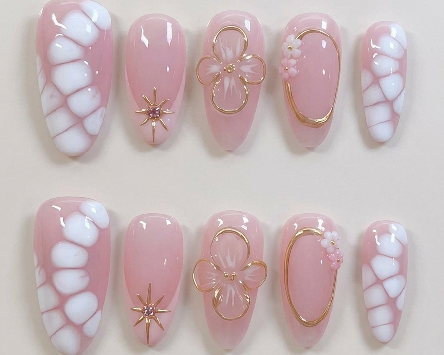 Set of pink and white nail designs with decorative elements on a light background