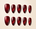 Set of red nail polish samples on a beige background