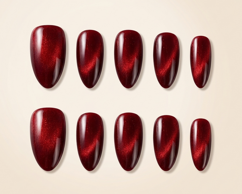 Set of red nail polish samples on a beige background